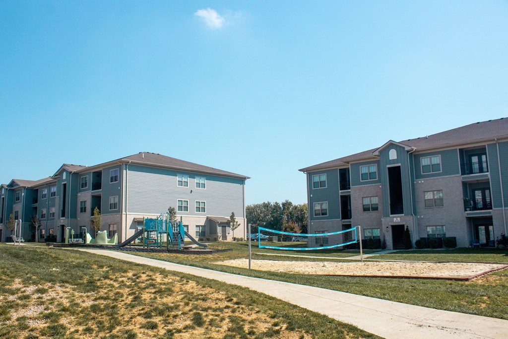 an image of an apartment building with a playground