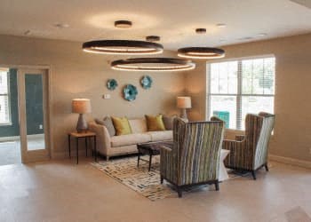 a living room with couches chairs and a table