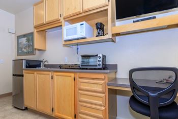 A Kitchen With a Black Chair at Atrium Garden Apartment Homes, LLC, California, 95112