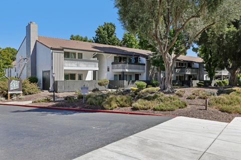 A modern building with a grey facade and a brown roof.