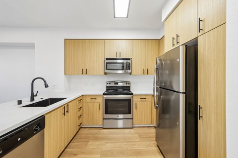 A kitchen with wooden cabinets and stainless steel appliances.