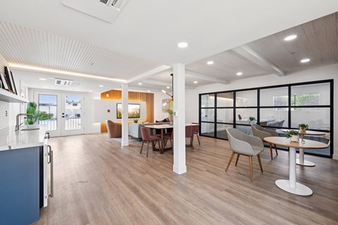 A modern kitchen with a dining table and chairs.