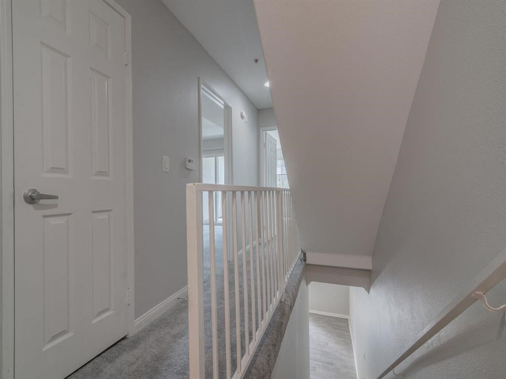 the landing of a staircase in a home with a white door at Warner Center Townhomes, Canoga Park California