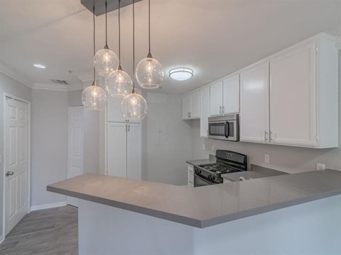a kitchen with white cabinets and a counter top