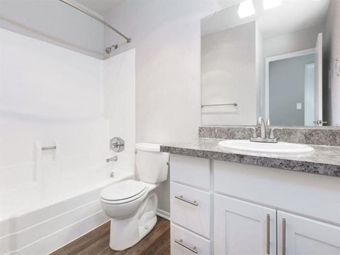 a white bathroom with a sink and a toilet at Skyline Heights Apartments, California, 94015