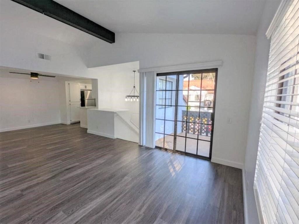 an empty living room with a door to a balcony  at The Resort at Encinitas Luxury Apartment Homes, Encinitas, 92024