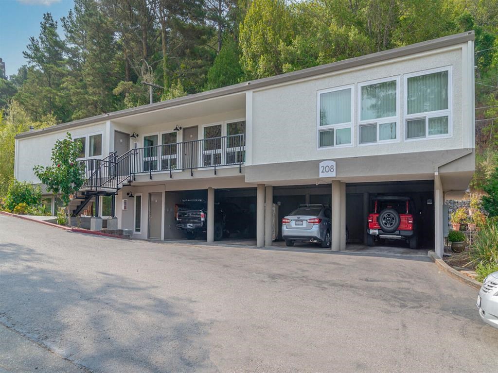 a large building with cars parked in the garage at Trailhead Apartments at Tam Junction, Mill Valley California