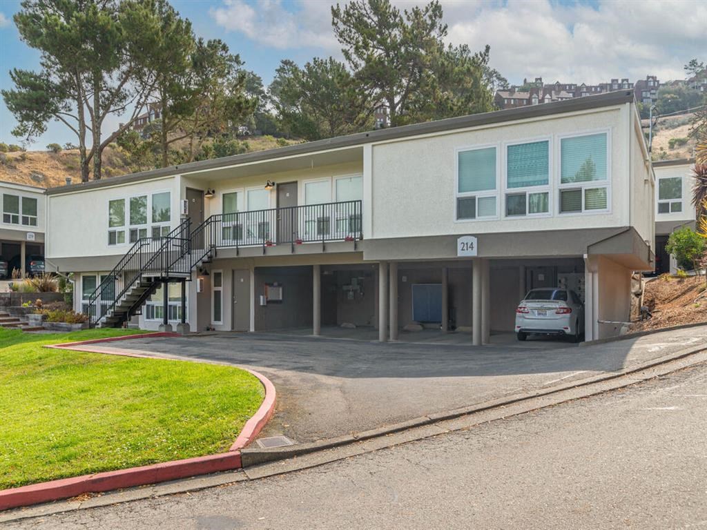 a building with a car parked in front of it at Trailhead Apartments at Tam Junction, Mill Valley