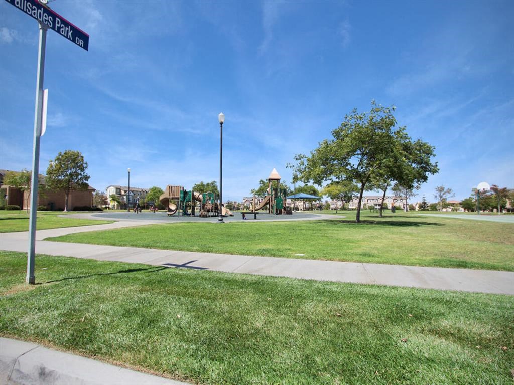 a park with a playground and a street sign at The Vines at Riverpark, LLC, California