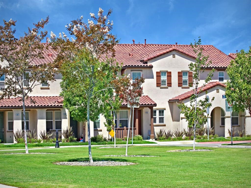 a large house with trees in front of it at The Vines at Riverpark, LLC, Oxnard, CA 93036