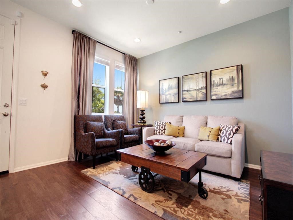 a living room with a couch and a table at The Vines at Riverpark, LLC, Oxnard, CA