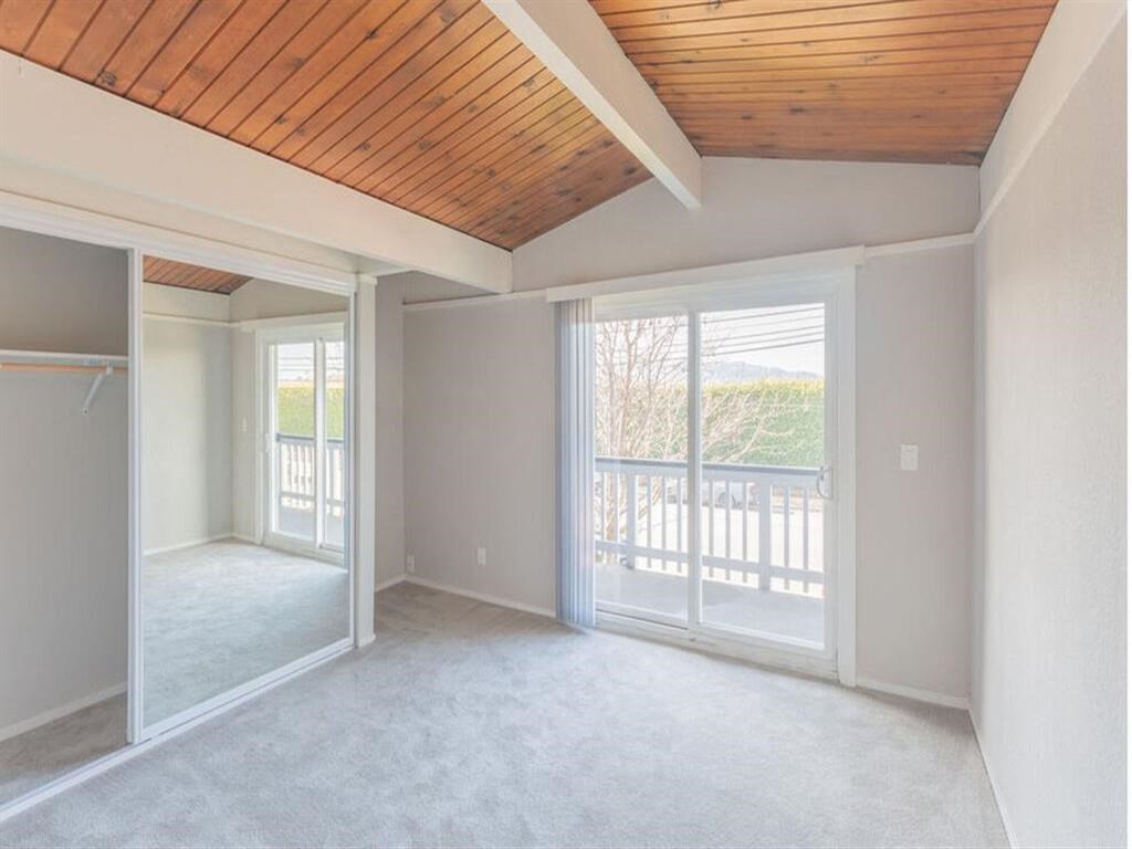 an empty living room with sliding glass doors to a balcony at The Preston at Hillsdale, San Mateo, California