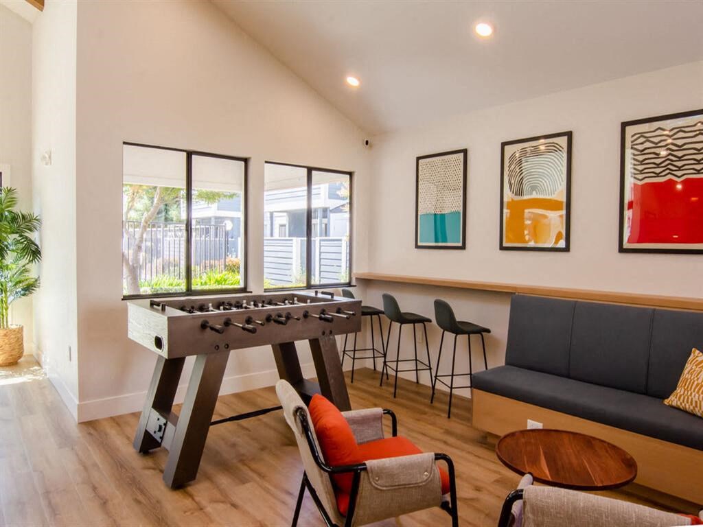 a game room with a foosball table and chairs at Parc Medallion LLC, Union City