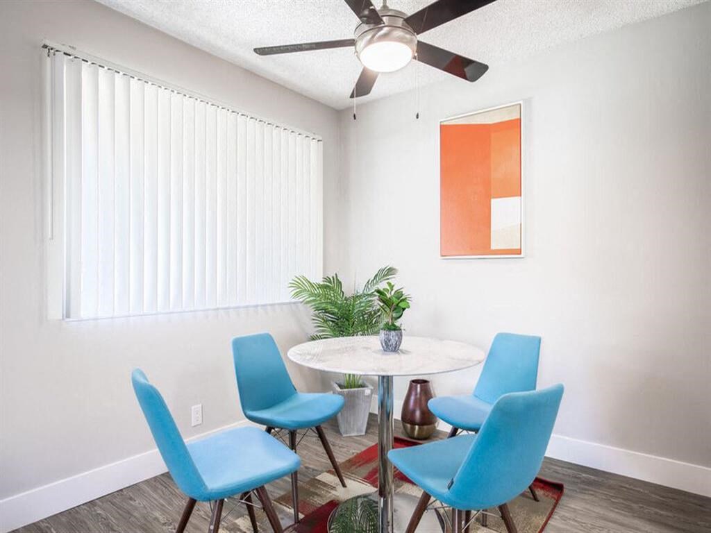 a dining room with a table and chairs and a ceiling fan at Parc Medallion LLC, Union City, CA