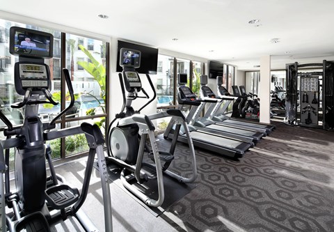 A gym with treadmills and elliptical machines. at Cirrus Redwood City Apartments, Redwood City, CA, 94061