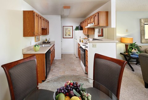 A kitchen with a table and chairs in the foreground.
