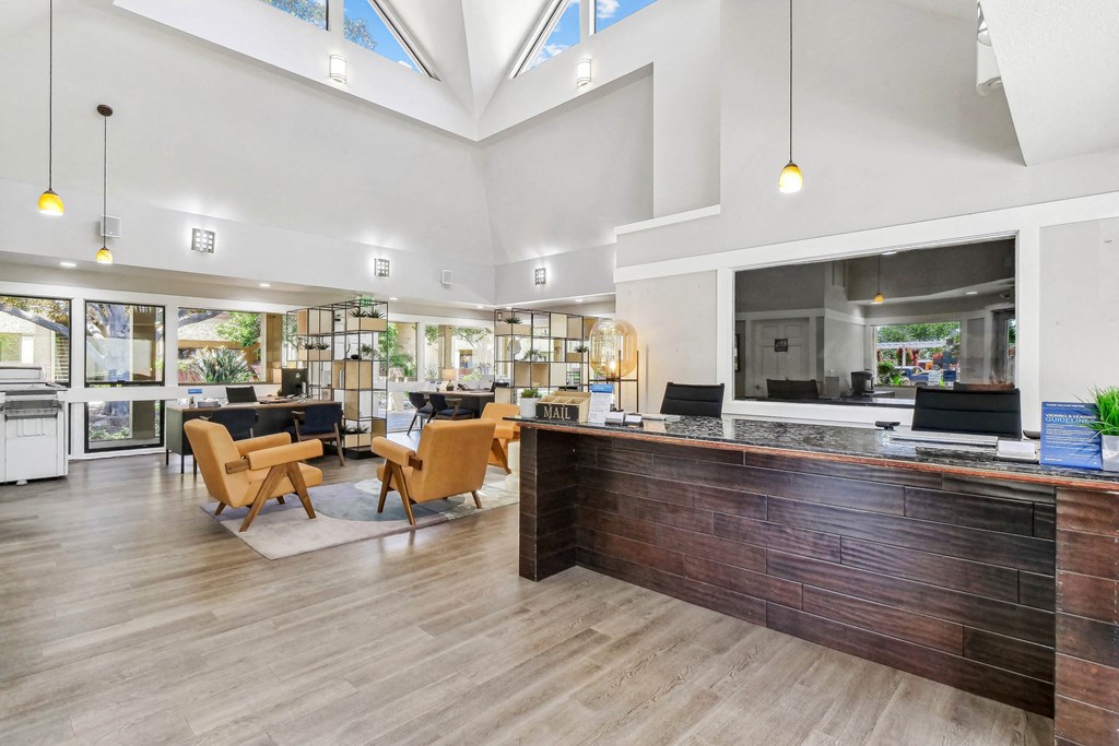 the lobby of a hotel with a reception desk and chairs at Summerwood Apartments, Santa Clara, CA