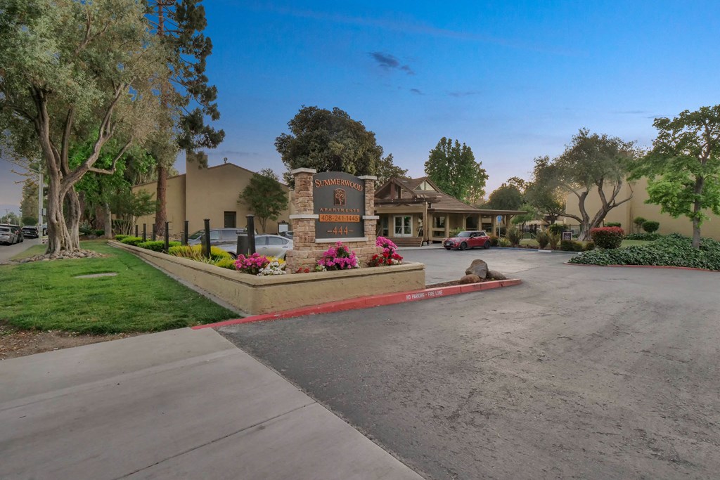a street in front of a house with a driveway and a sign at Summerwood Apartments, Santa Clara, California