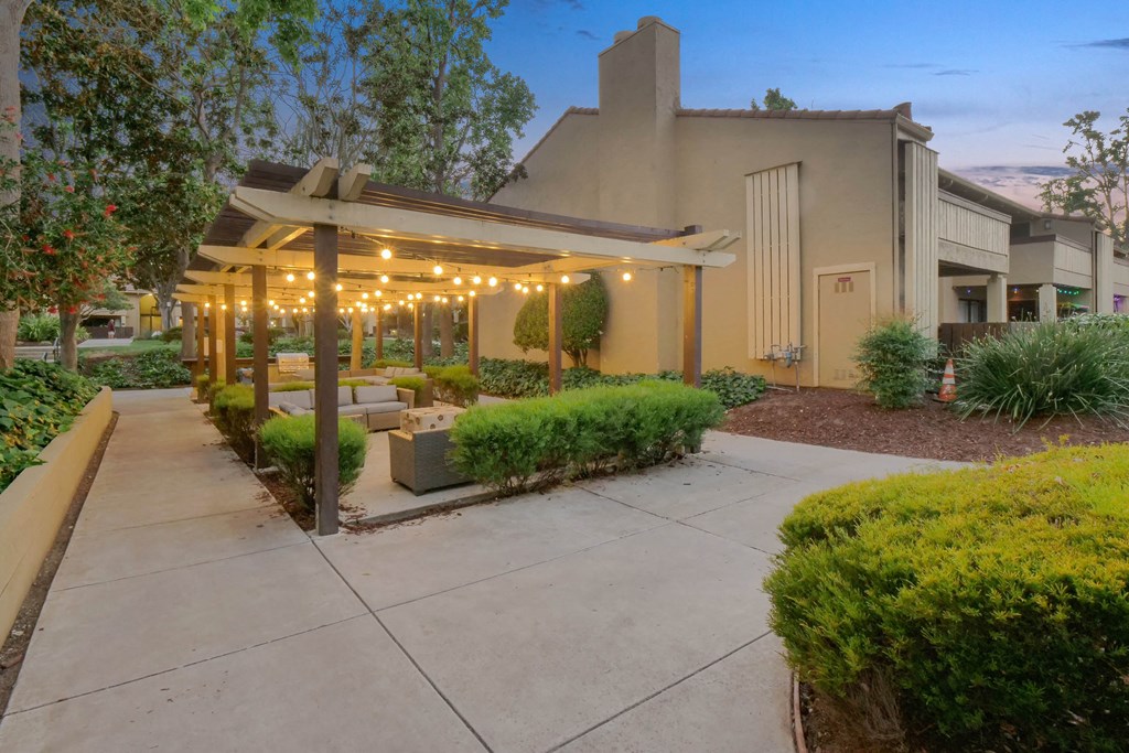 a patio with benches and a pavilion with lights at Summerwood Apartments, Santa Clara