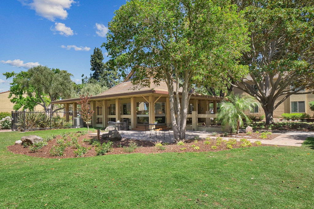 a view of a house with trees and grass at Summerwood Apartments, Santa Clara, CA