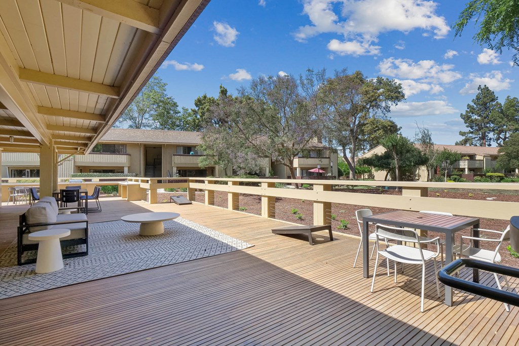 a patio with tables and chairs on a balcony at Summerwood Apartments, Santa Clara, CA 95050