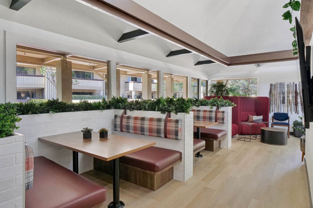 a lobby with red chairs and potted plants at Summerwood Apartments, Santa Clara, CA 95050