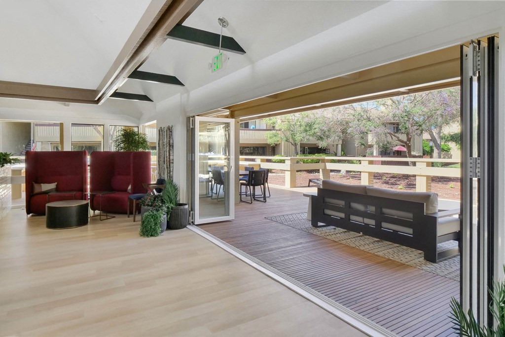 a living room with sliding glass doors to a patio at Summerwood Apartments, Santa Clara, California