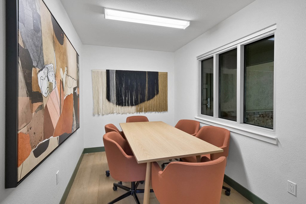a conference room with a wooden table and chairs at Summerwood Apartments, Santa Clara