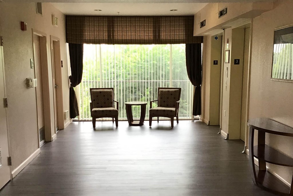 A Room With Two Chairs And a Table In Front Of a Window at Atrium Garden Apartment Homes, LLC, San Jose, CA, 95112