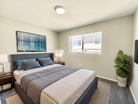A bedroom with a large bed and a painting on the wall.