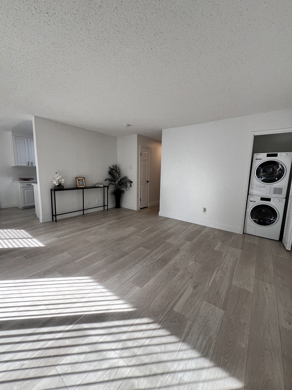 a living room with a washer and a dryer in it at Campbell West Apartments, Campbell, California