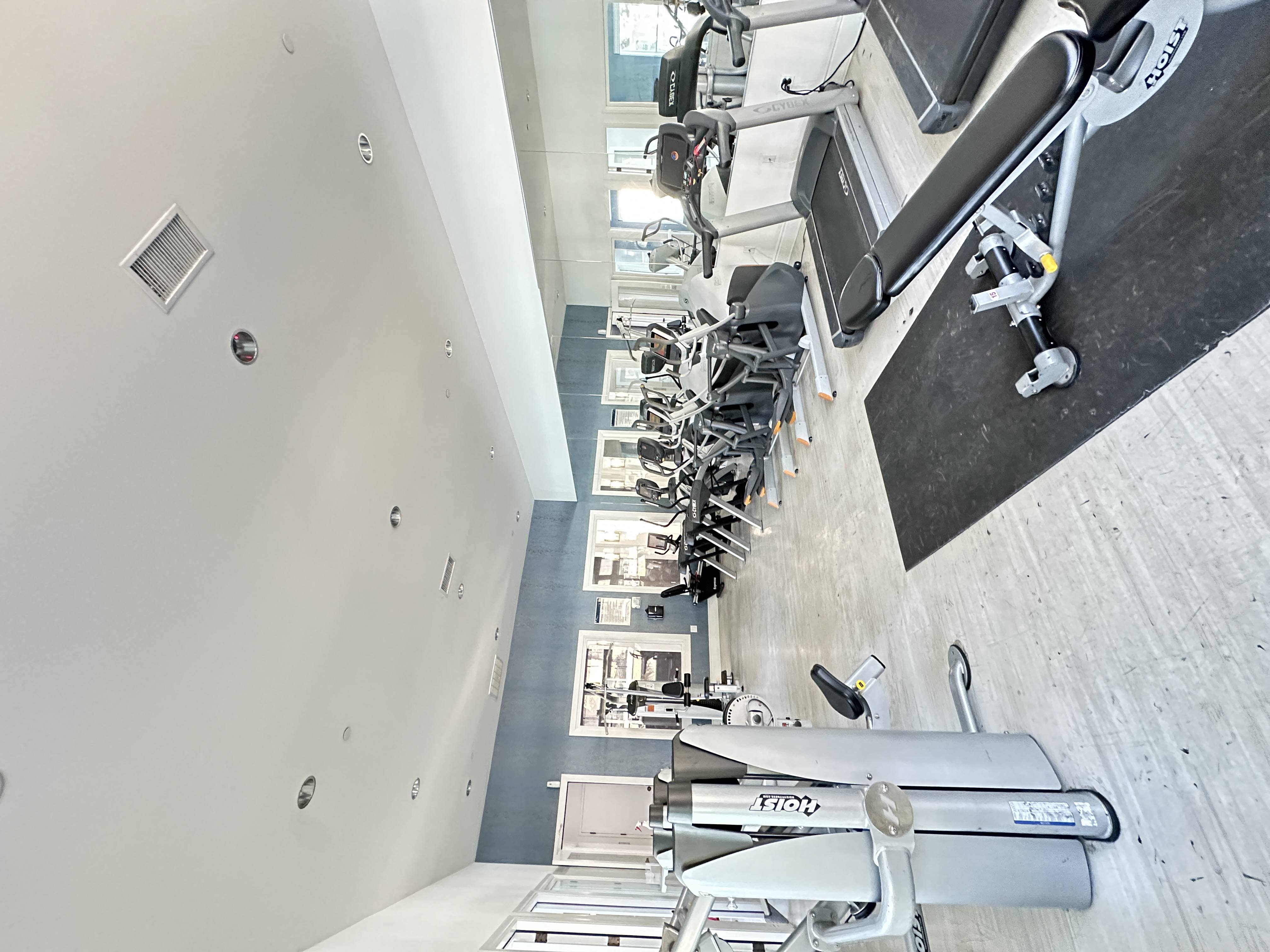 a view of ellipticals and treadmills in a spacious gym at The Bryant Apartments at Yorba Linda, Yorba Linda, 92887