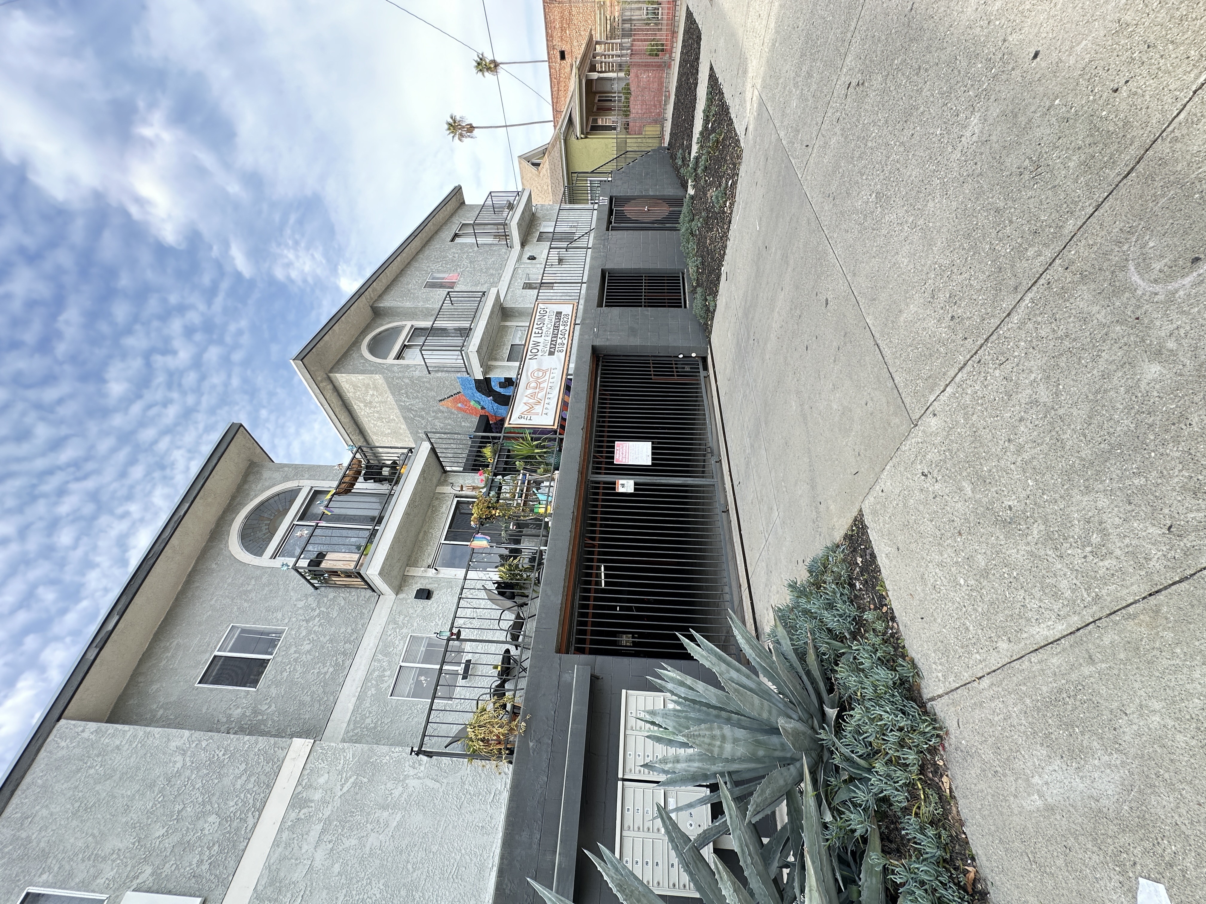 a view of a gated garage and apartment building