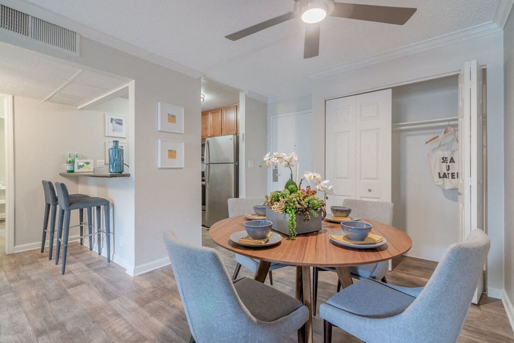 a dining room and kitchen with a table and chairs at City View Apartments at Warner Center, Woodland Hills, 91367