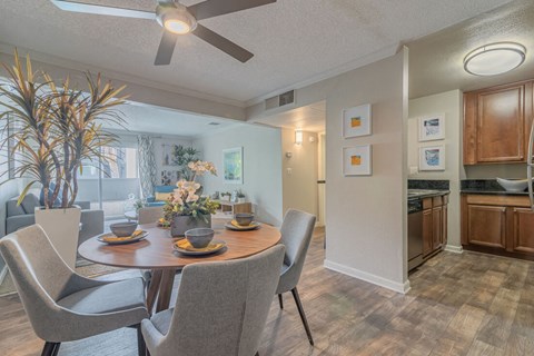 a dining room and kitchen with a table and chairs