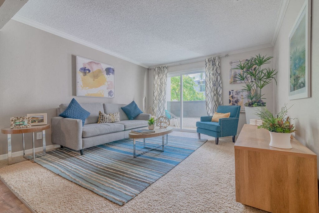 a living room with a couch and a chair at City View Apartments at Warner Center, Woodland Hills