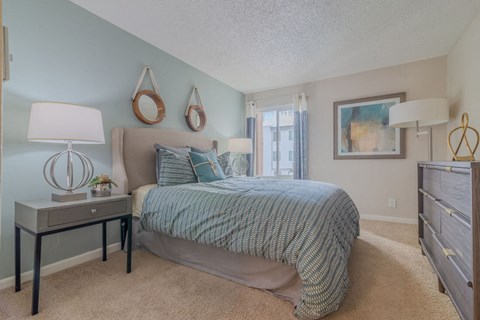a bedroom with a large bed and a window