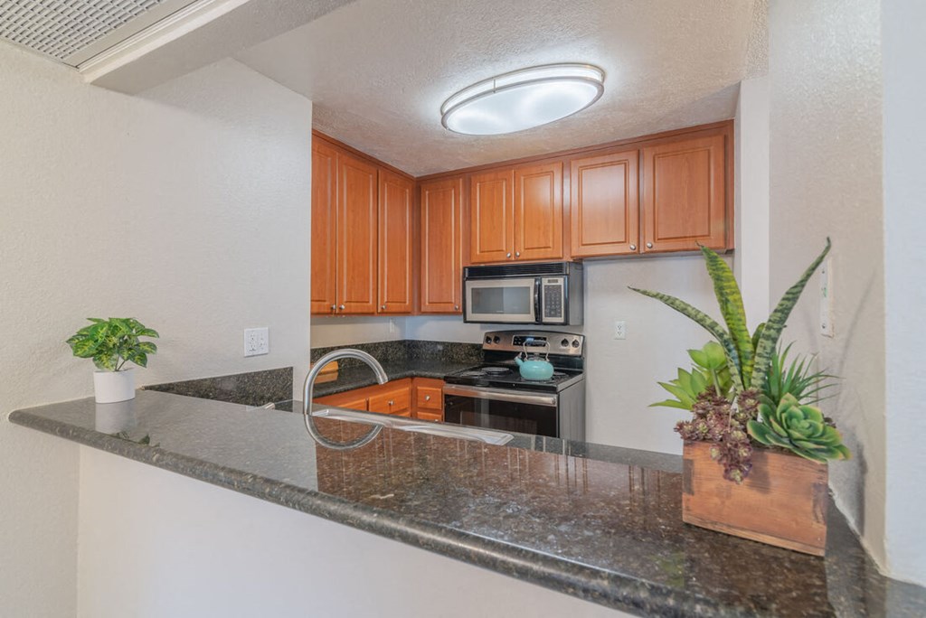 a kitchen with a granite counter top and at City View Apartments at Warner Center, California