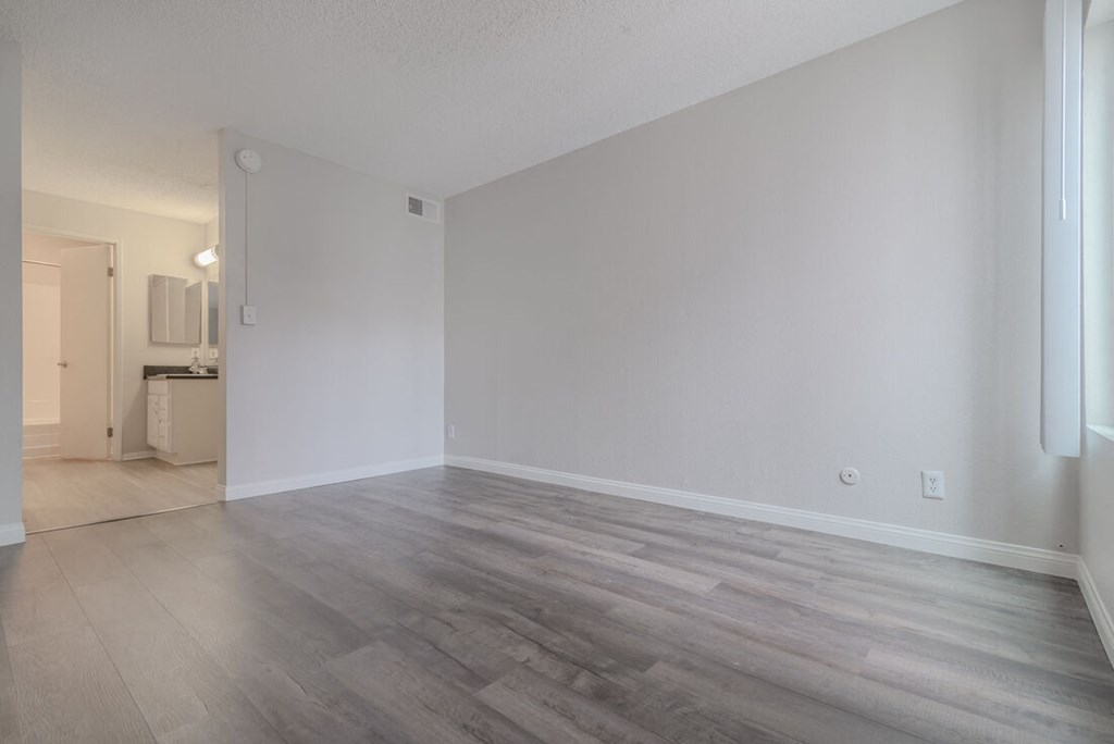 an empty living room with wood flooring and white walls at City View Apartments at Warner Center, Woodland Hills, CA 91367
