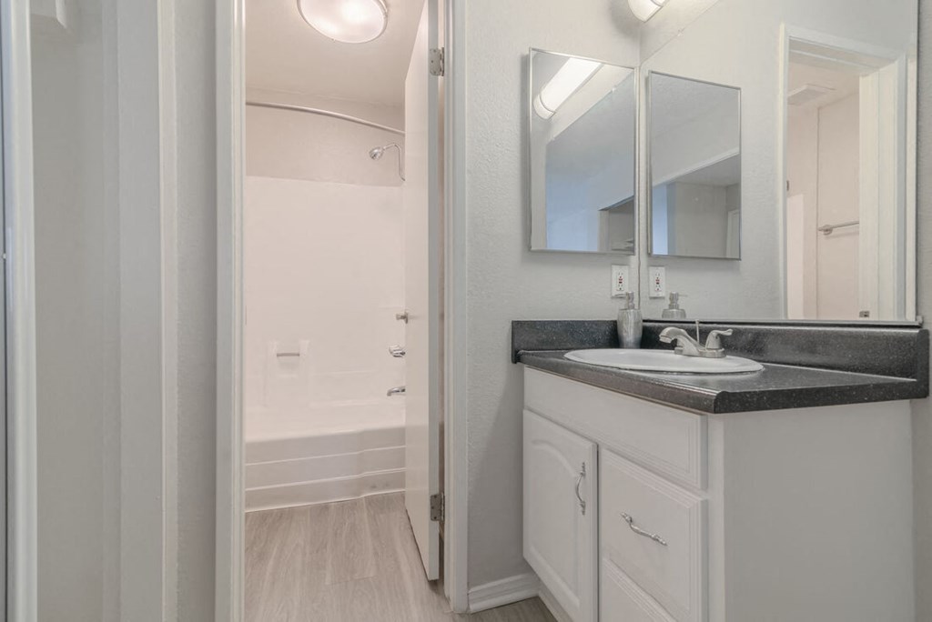 a bathroom with a sink and a mirror at City View Apartments at Warner Center, California, 91367