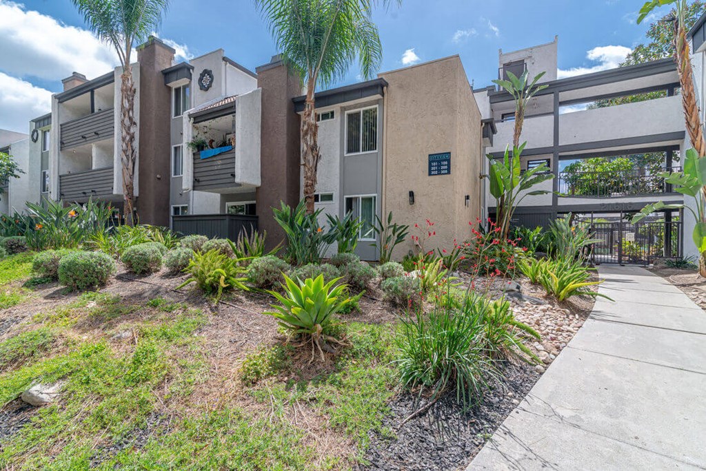 a house with a sidewalk and plants in front of it at City View Apartments at Warner Center, Woodland Hills