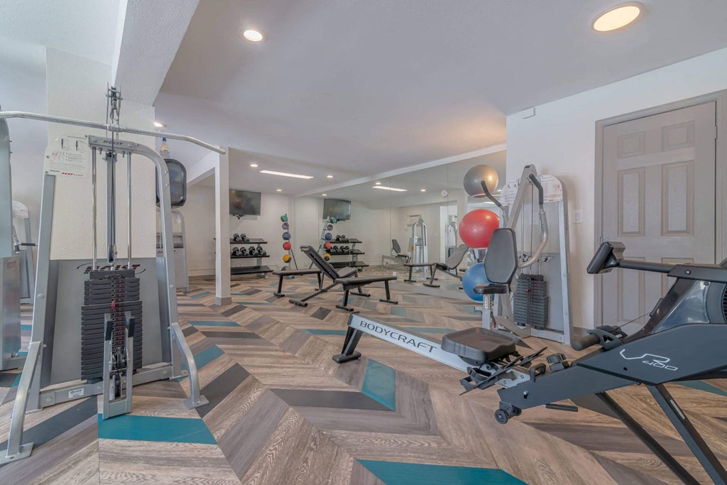 a gym with weights and cardio equipment in a home gym at City View Apartments at Warner Center, Woodland Hills, 91367