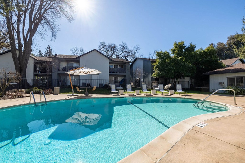 our apartments have a large pool with chairs and umbrellas at Danville Park, California