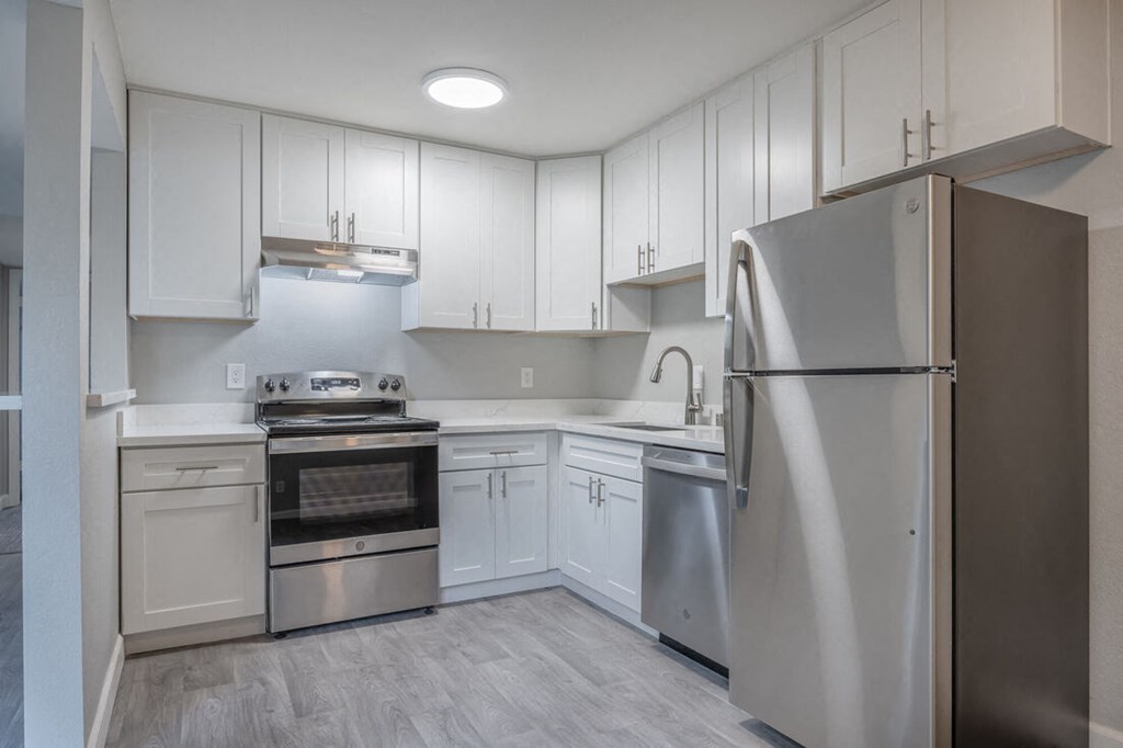 a white kitchen with stainless steel appliances and white cabinets  at Danville Park, Danville, CA