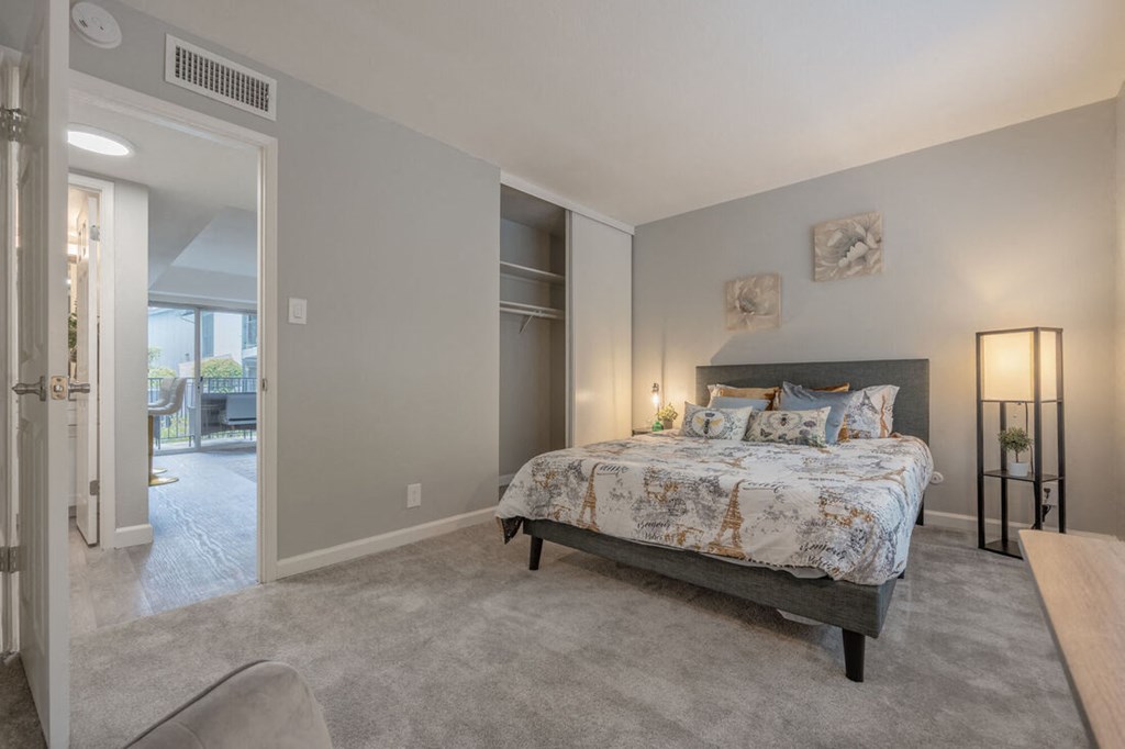 a bedroom with a bed and a door to a living room at Danville Park, Danville, California