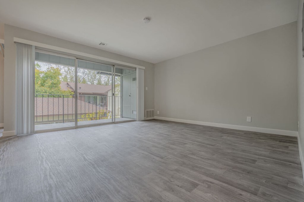 an empty living room with a sliding glass door to a balcony  at Danville Park, California, 94526