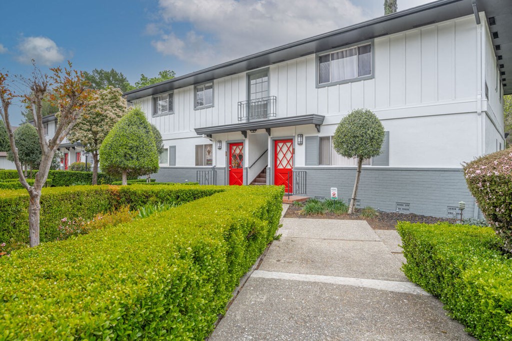 a white house with red doors and a sidewalk in front of it at Danville Park, Danville, 94526