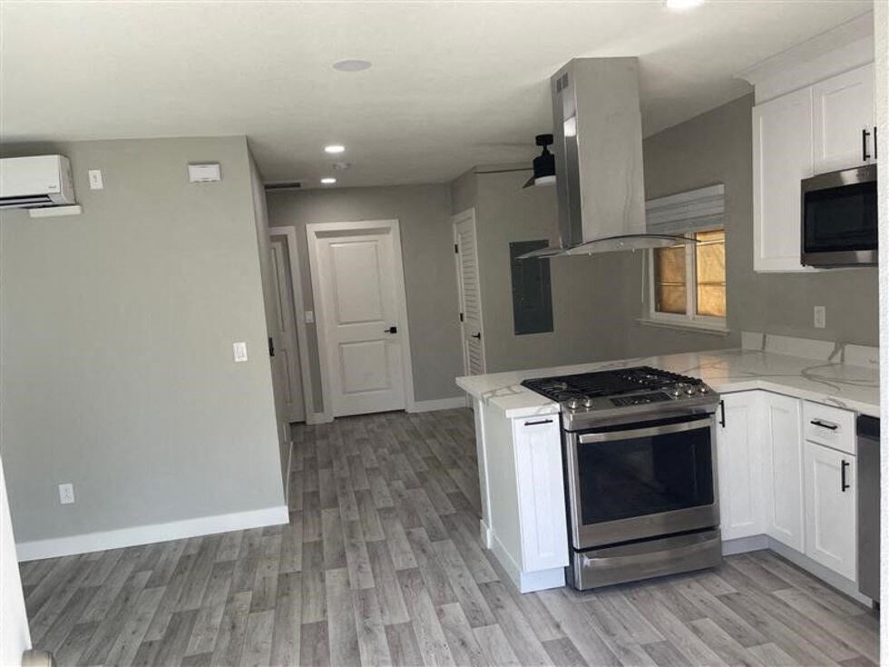 an empty kitchen with white cabinets and a stove  at Danville Park, Danville, California