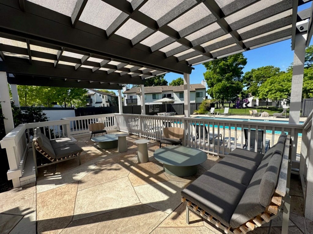 a view of the pool from a patio with chairs and awning at Diablo Vista, Livermore, CA