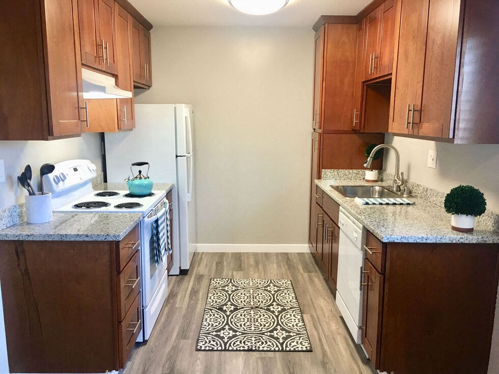 a kitchen with wooden cabinets and a white refrigerator at Element LLC, Sunnyvale, CA